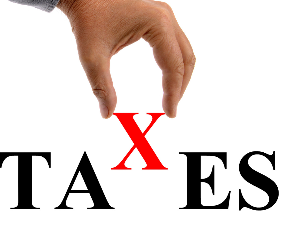 Hand putting the X in the word taxes.