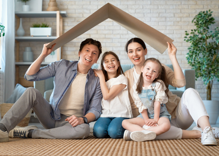 Parents sitting with two daughters under roof.