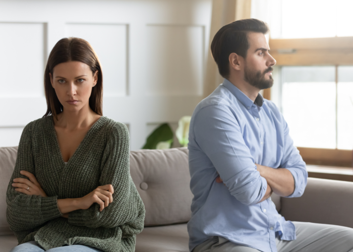 Woman and man sitting back-to-back