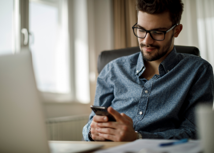 Man working on cell phone.