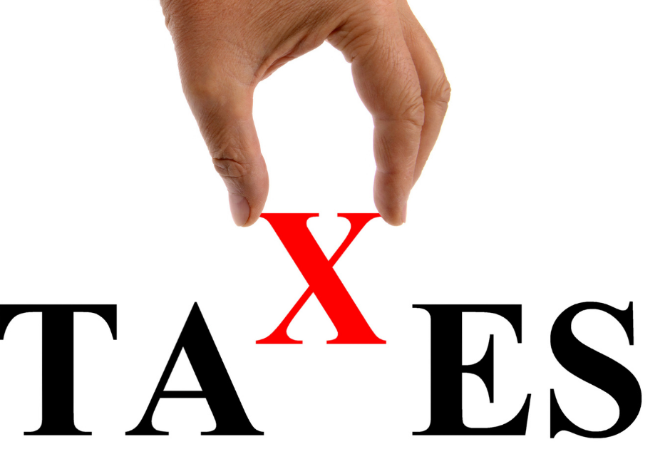 Hand putting the X in the word taxes.