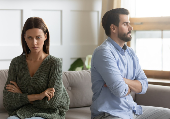 Woman and man sitting back-to-back