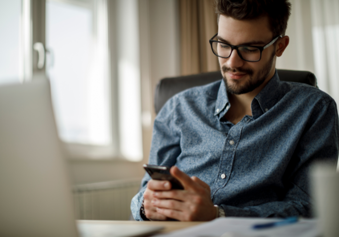 Man working on cell phone.